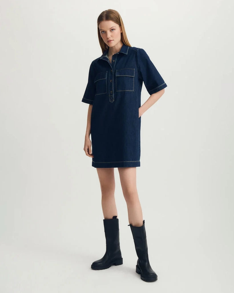 Woman wearing a blue denim dress with black boots