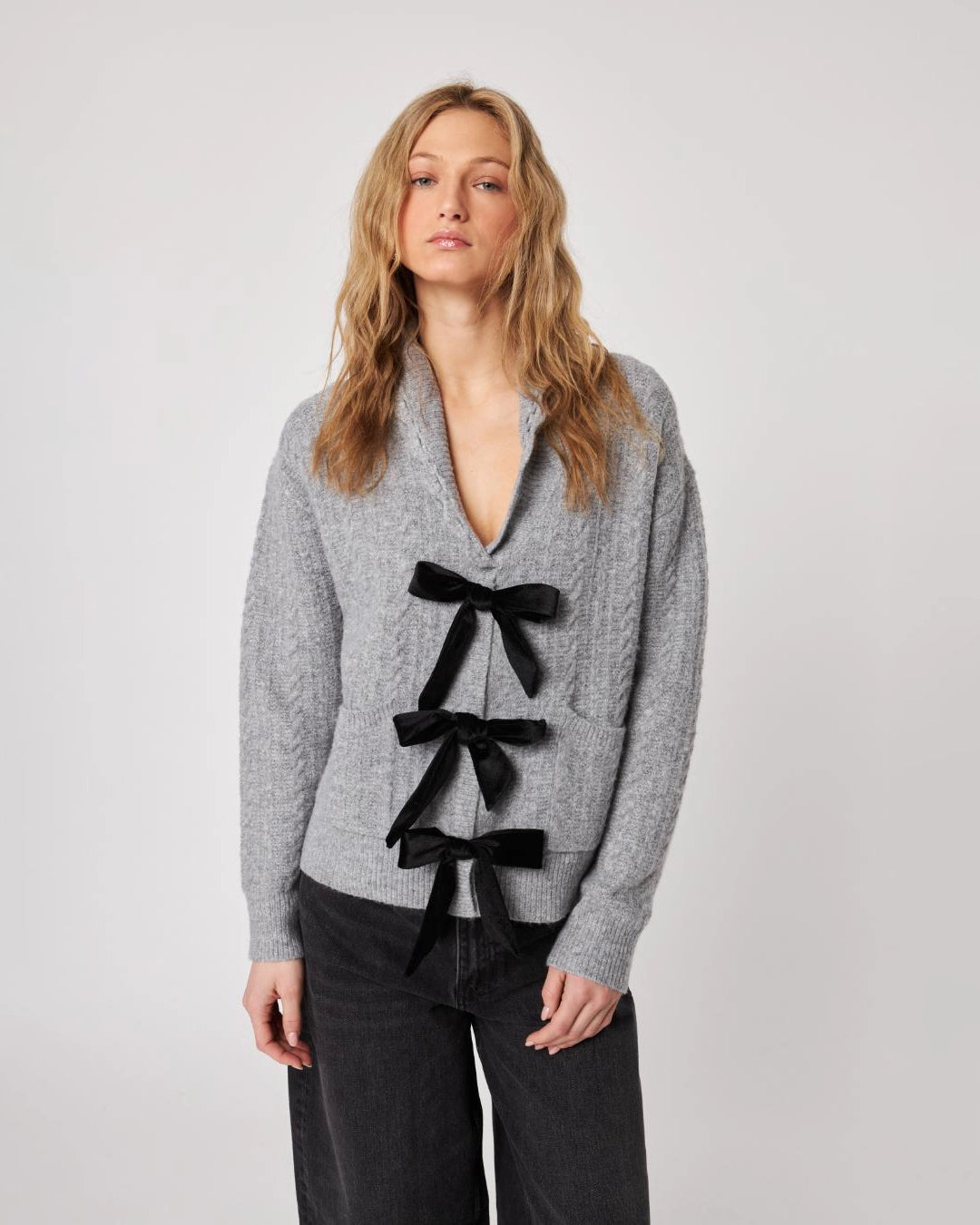 grey cardigan with three black bows down the front
