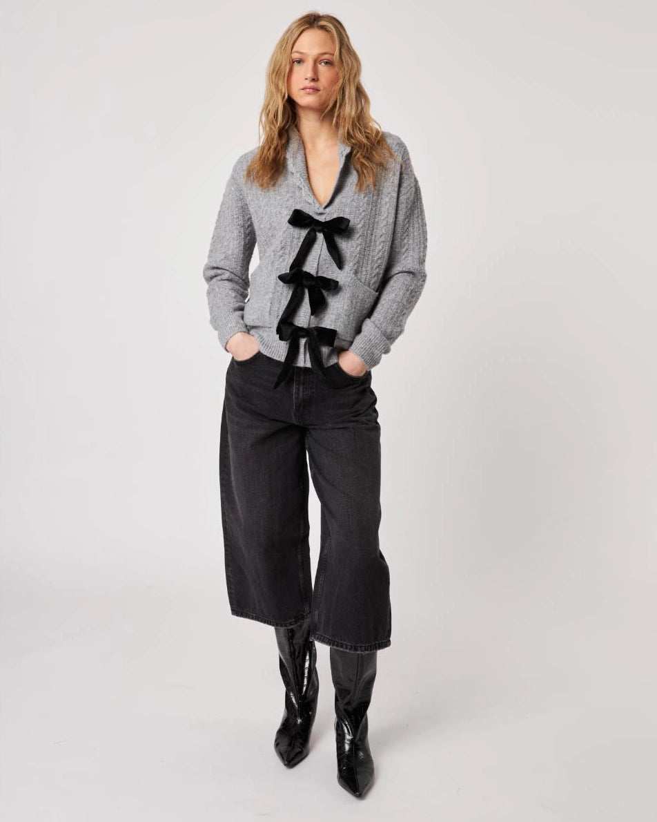 grey cardigan with three black bows down the front