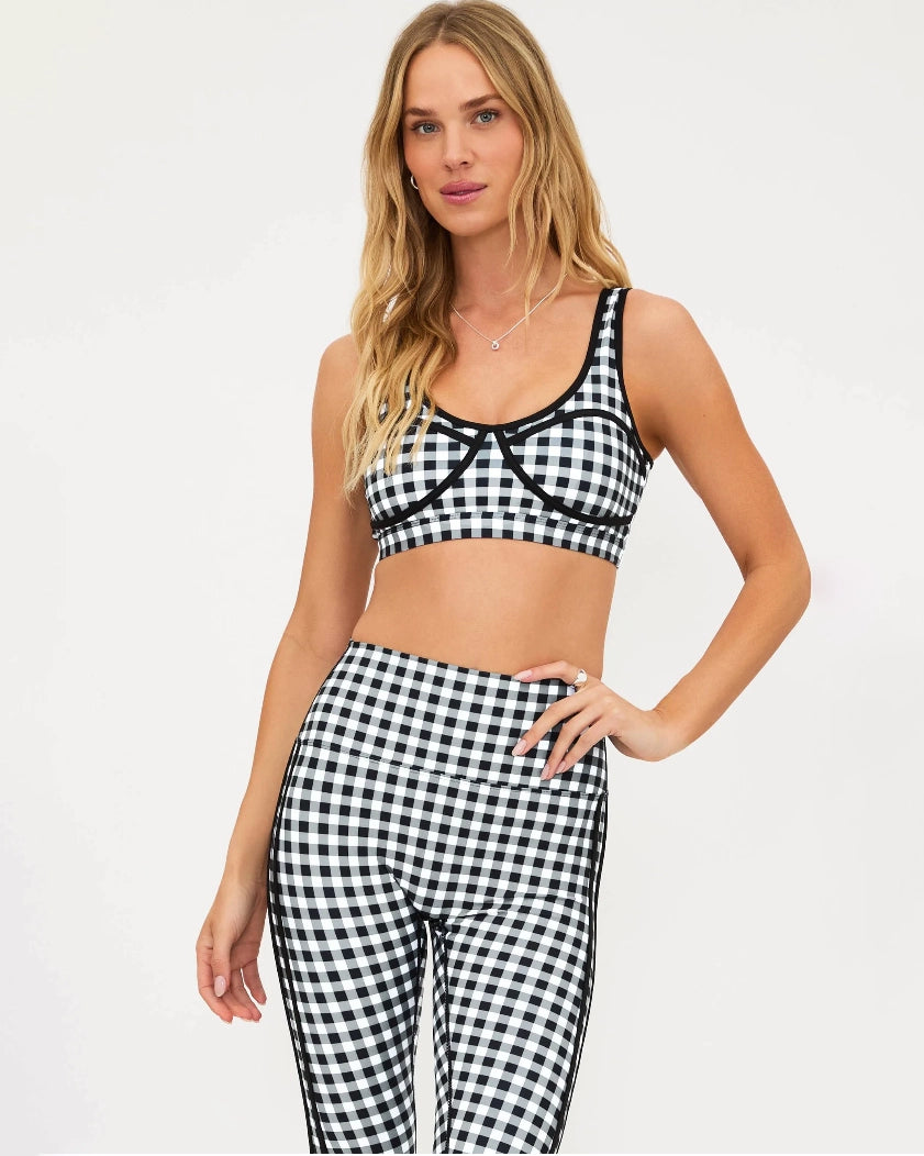 Woman wearing a black and white checkered bra top and matching leggings