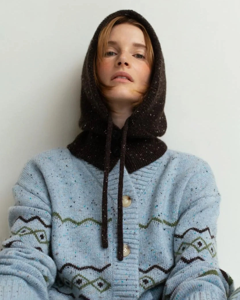 Person wearing a brown knitted hood hat