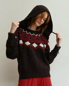 Person wearing a brown knitted hood hat