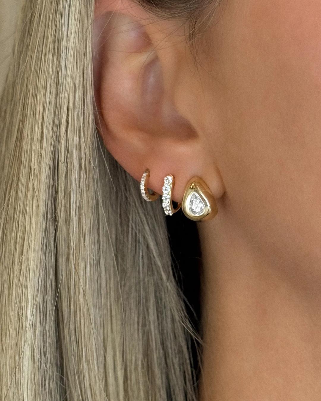 tear drop gold earrings with a diamond in the middle