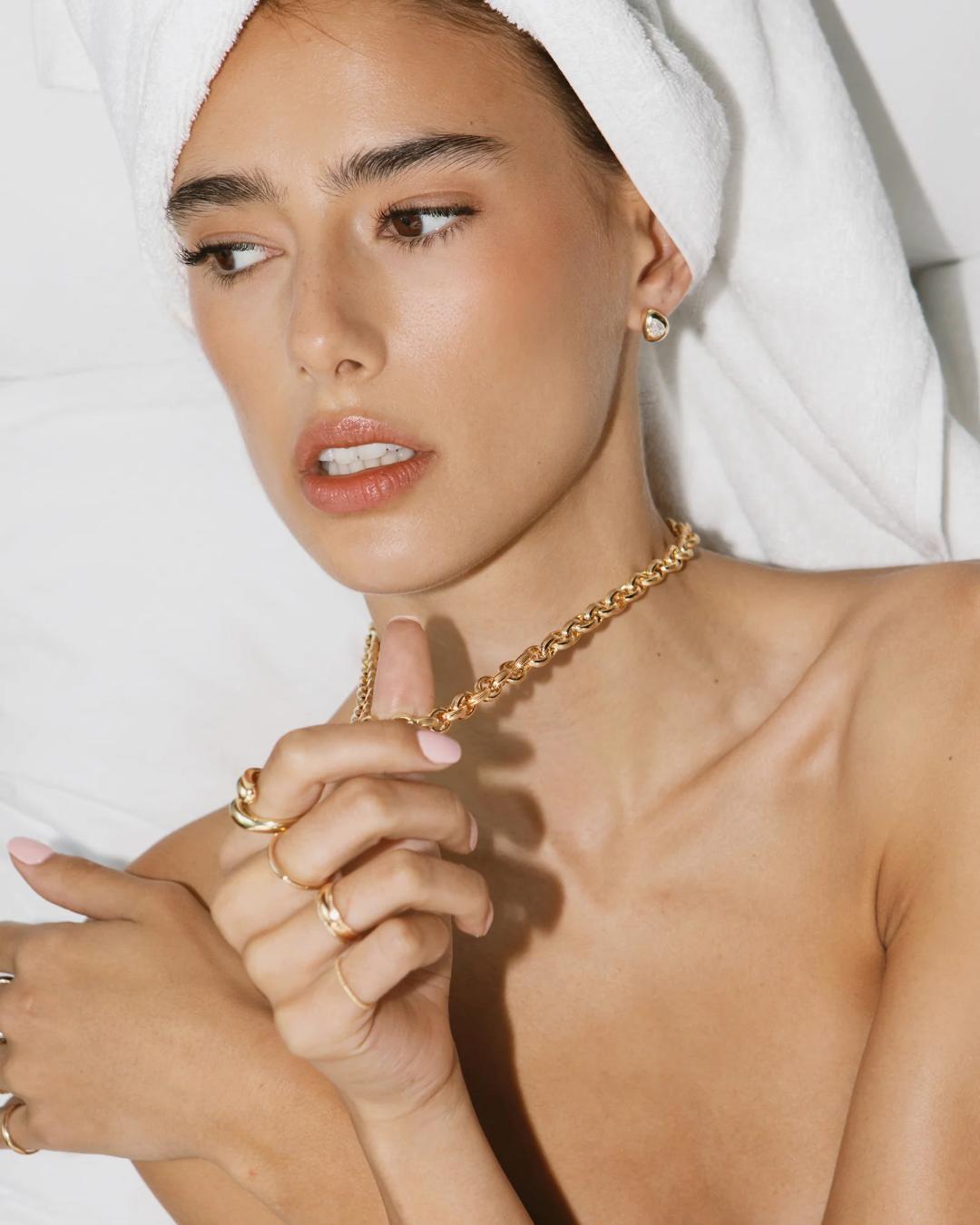 tear drop gold earrings with a diamond in the middle