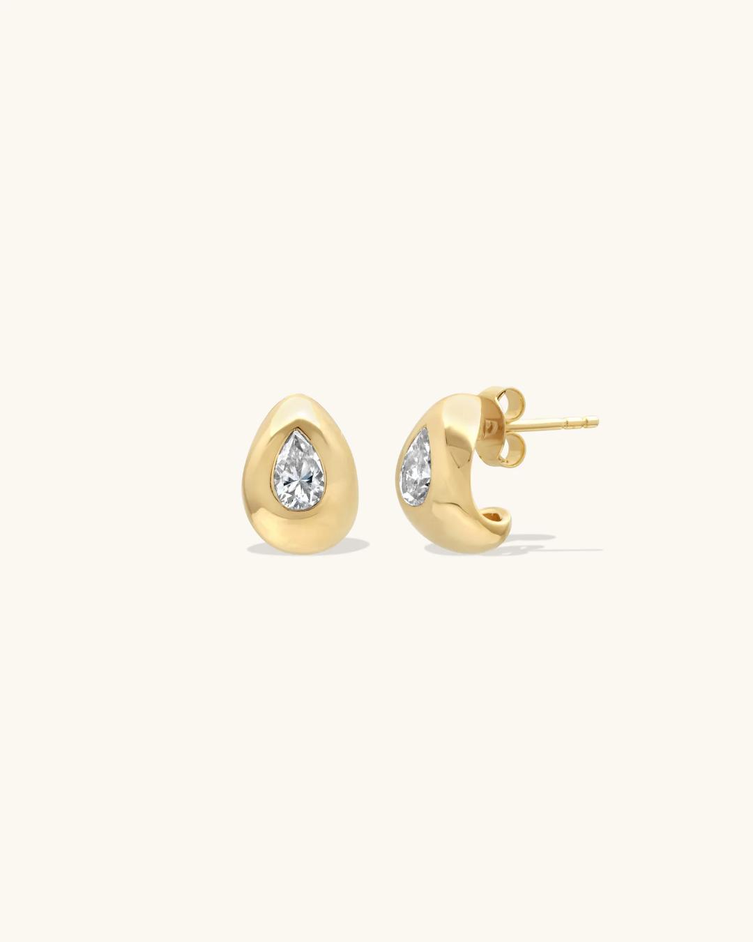 tear drop gold earrings with a diamond in the middle