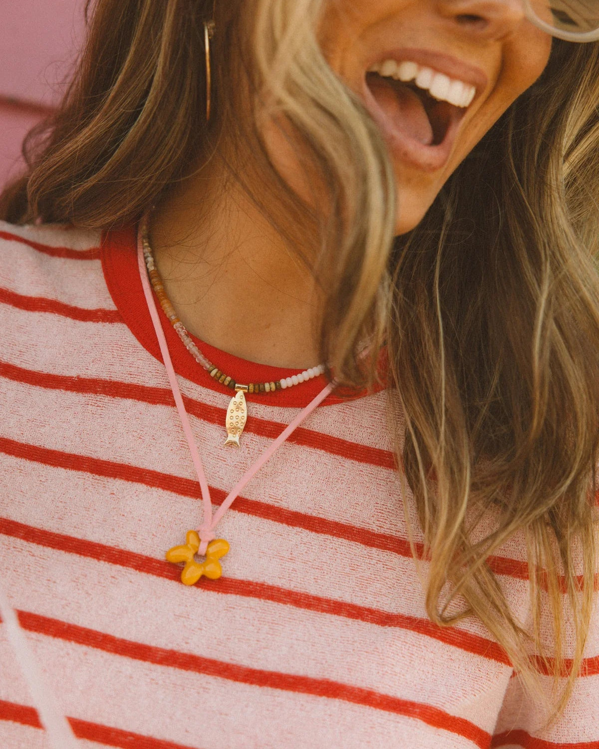 colorful beaded necklace with a gold fish pendant