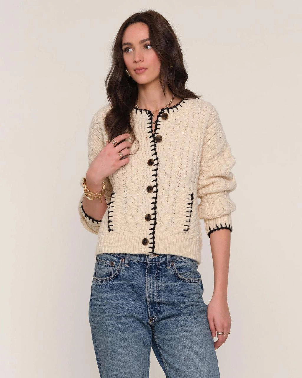 cream cardigan with black stitching outline