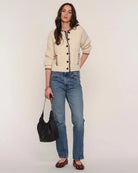 cream cardigan with black stitching outline