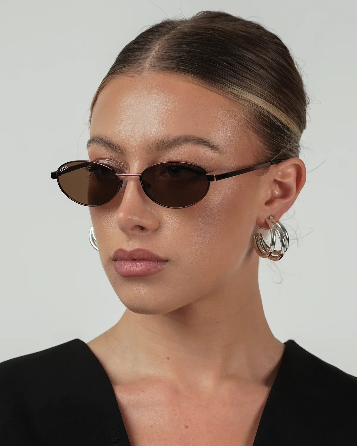 oval brown sunglasses with a thin frame