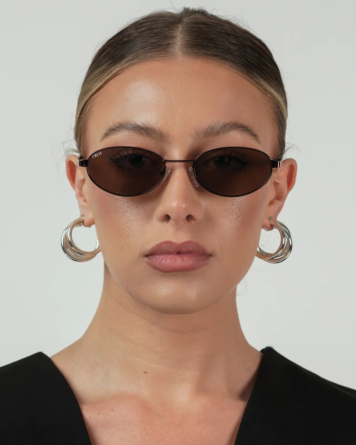 oval brown sunglasses with a thin frame