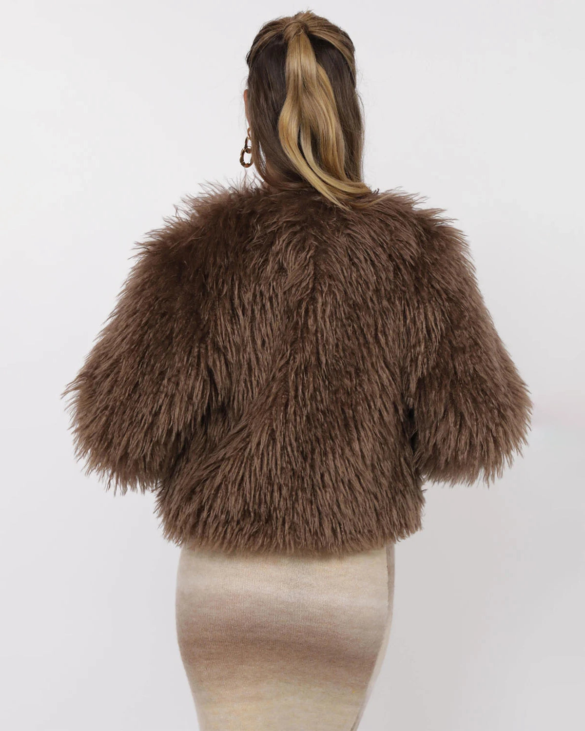 Woman wearing a brown fluffy faux fur jacket