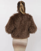 Woman wearing a brown fluffy faux fur jacket