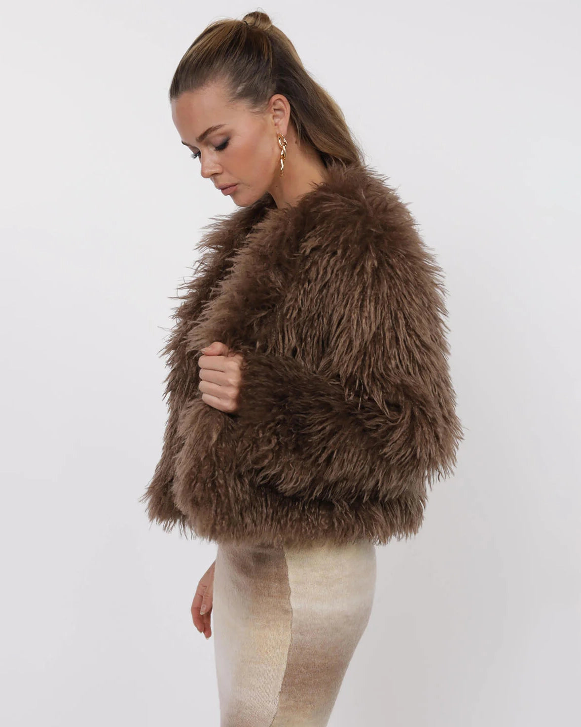 Woman wearing a brown fluffy faux fur jacket