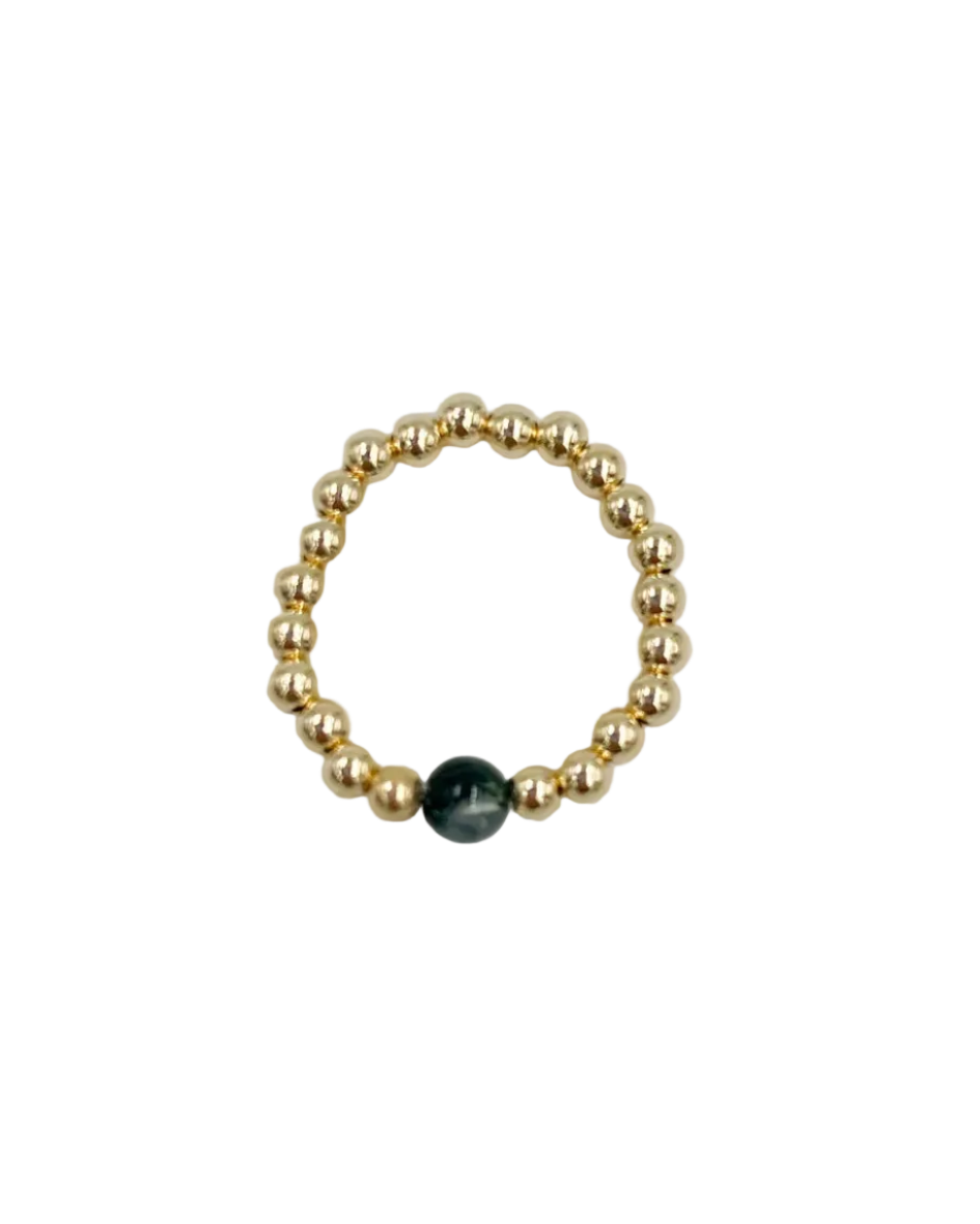 beaded gold ring with green stone in the middle