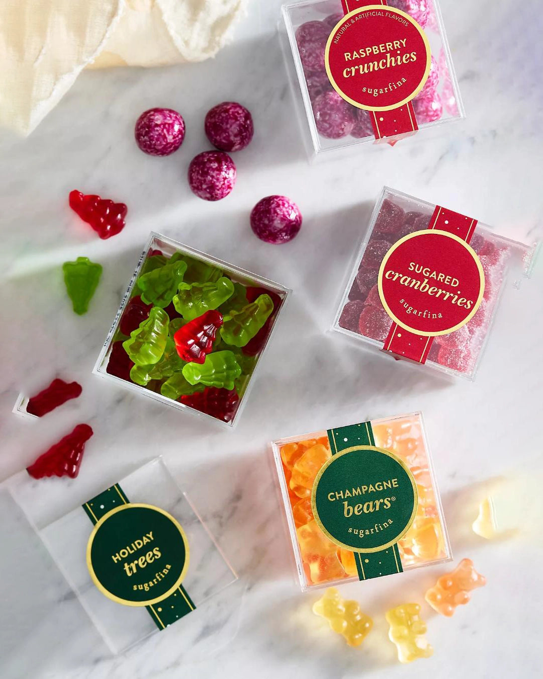 a photo of 4 boxes of christmas themed candy from the company sugarfina