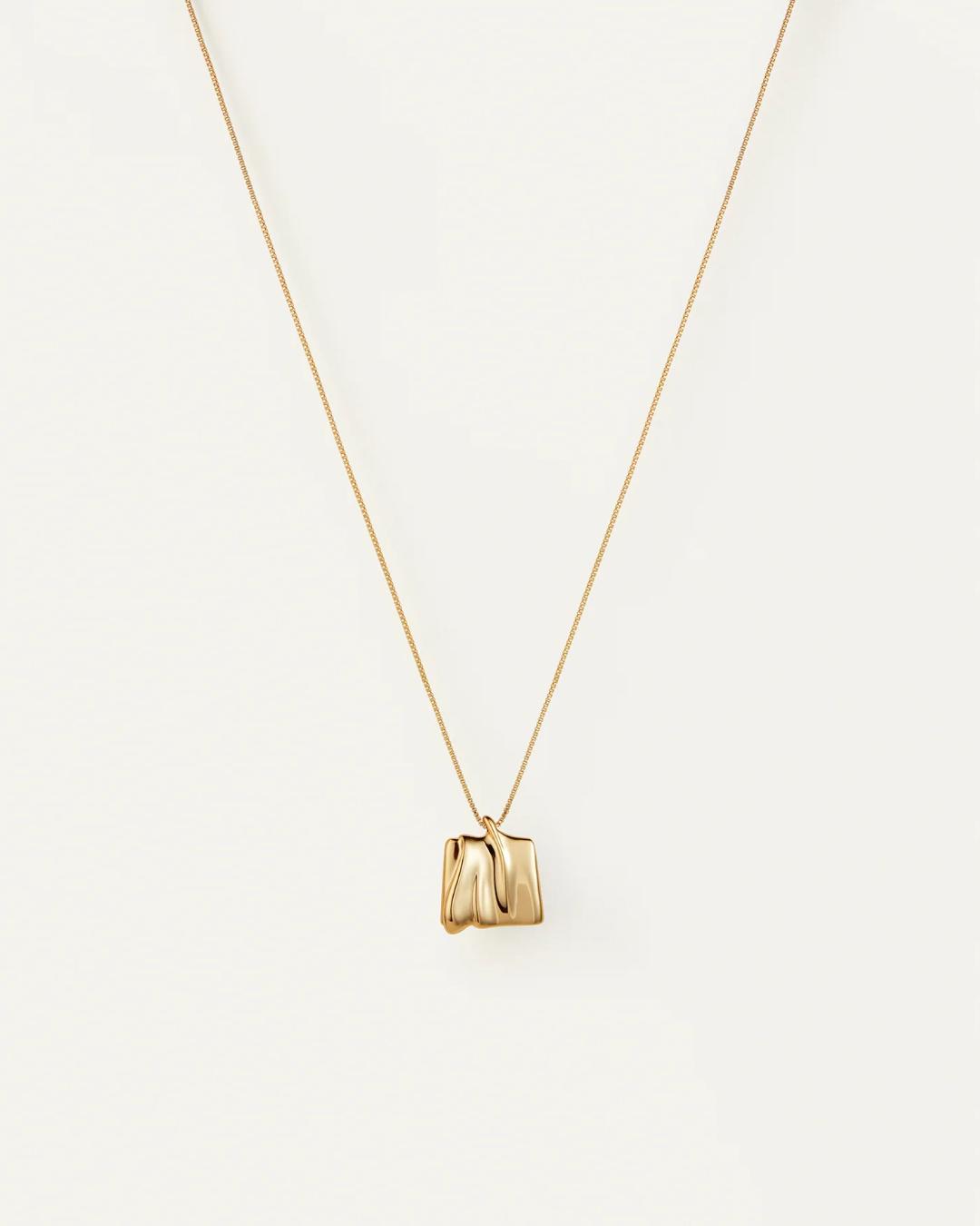 gold necklace with a square gold pendant