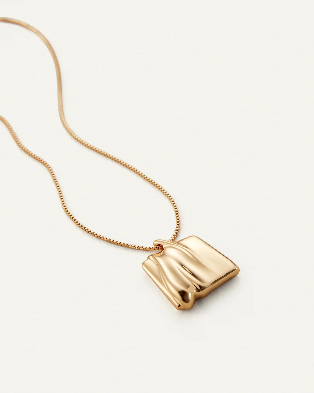 gold necklace with a square gold pendant