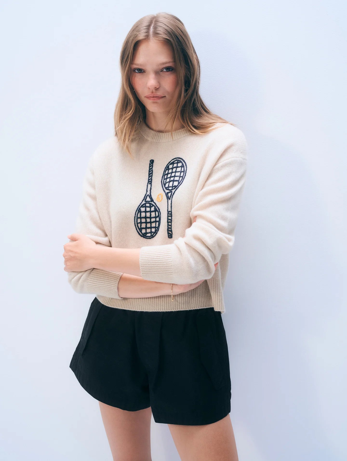 off white cashmere crewneck with embroidered tennis racquets on the front