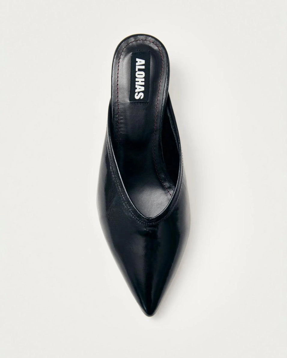 black leather mules with a pointed toe with 'Alohas' logo on them