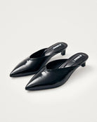 black leather mules with a pointed toe with 'Alohas' logo on them