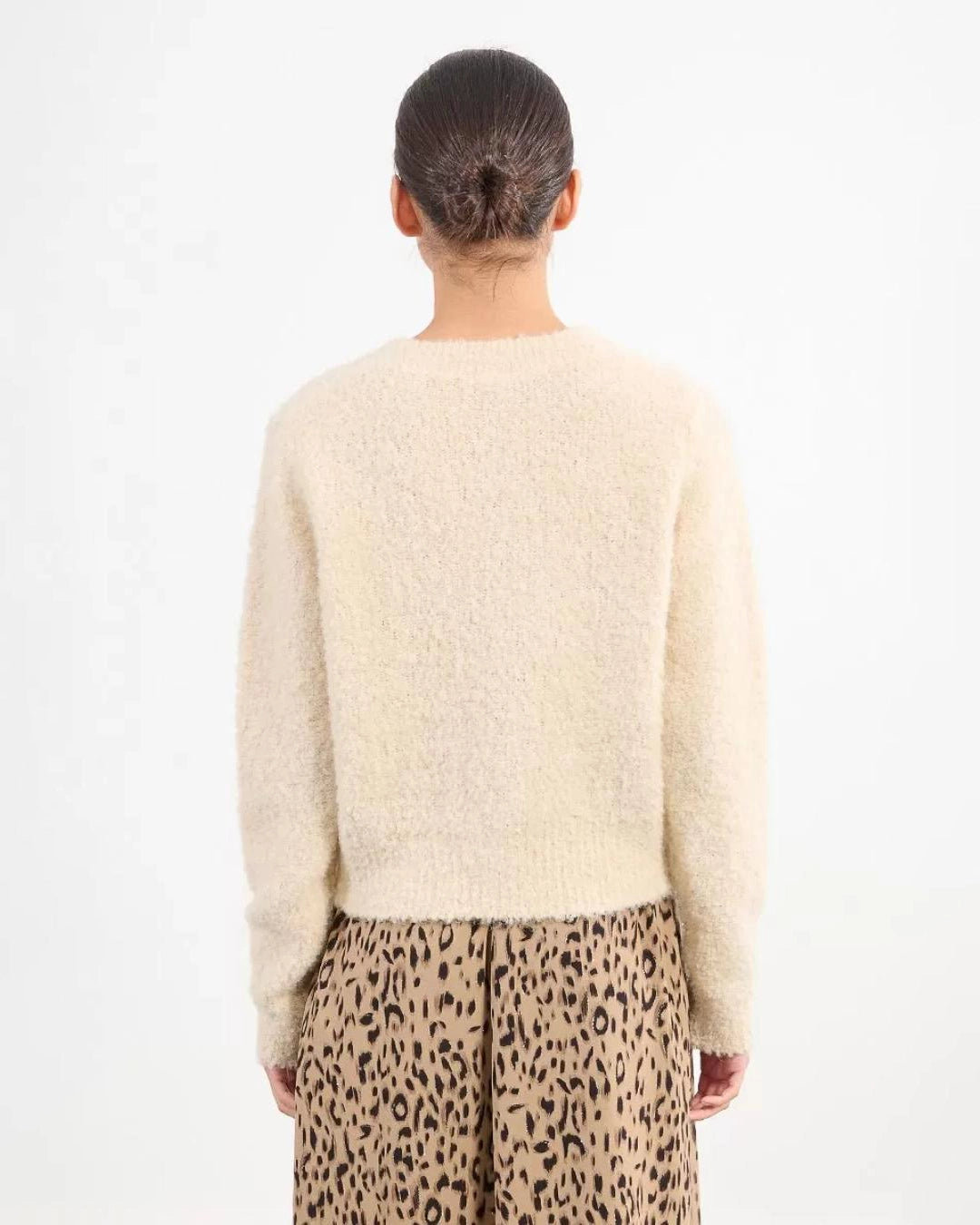 Woman wearing a beige fluffy cardigan