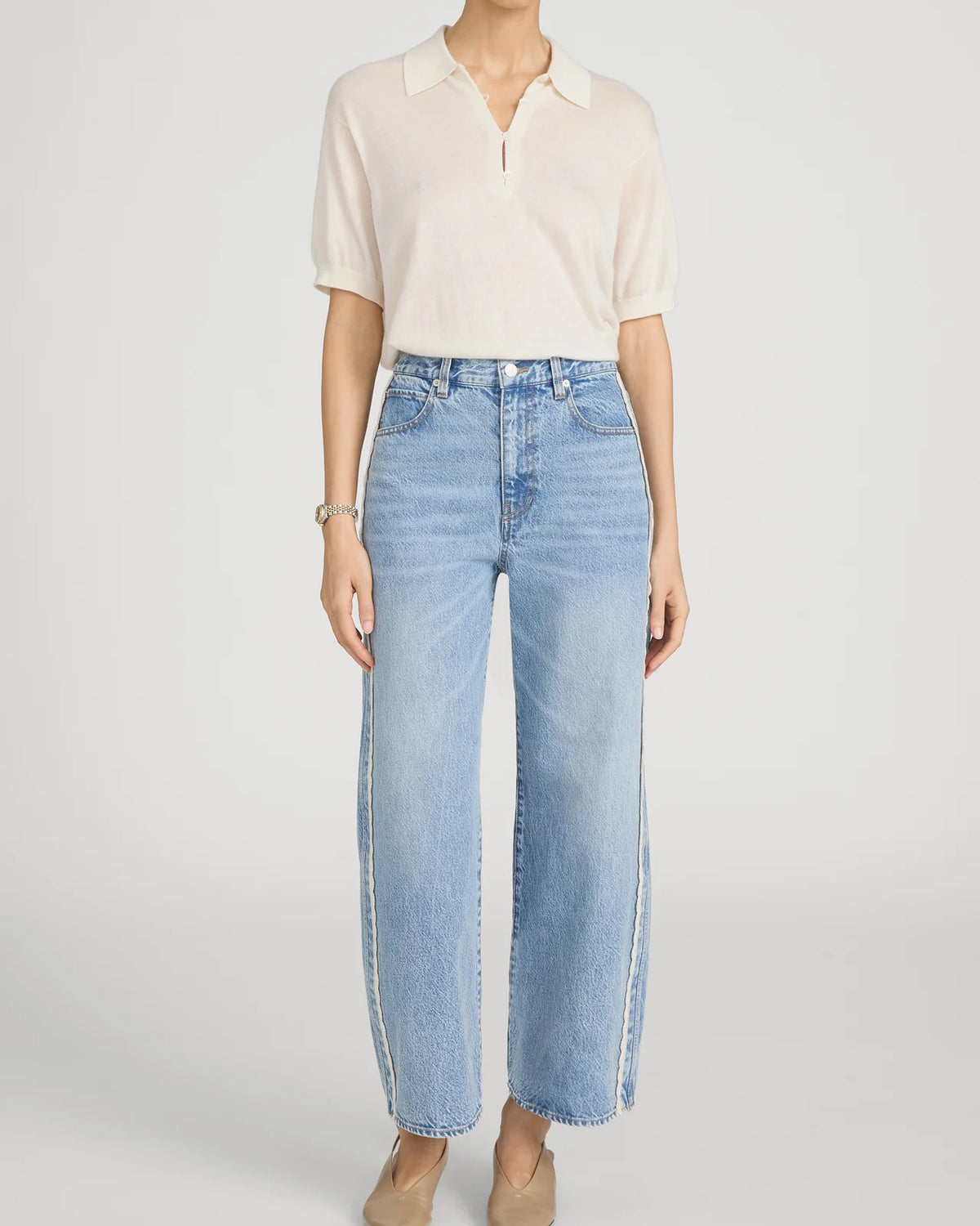 cropped light wash denim pant with a cream crochet detail on the sides