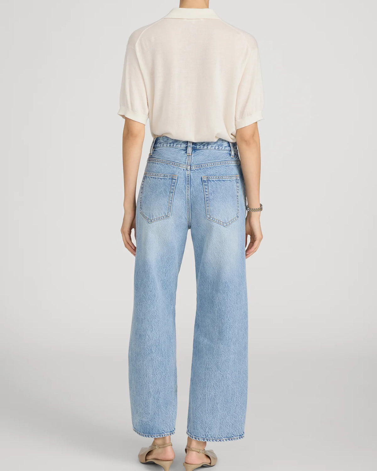 cropped light wash denim pant with a cream crochet detail on the sides