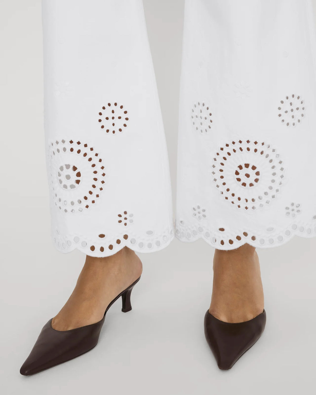 wide leg white denim pant with eyelet detail at the bottom
