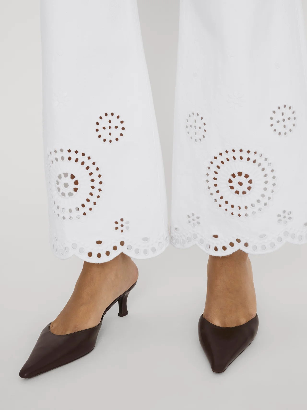 wide leg white denim pant with eyelet detail at the bottom