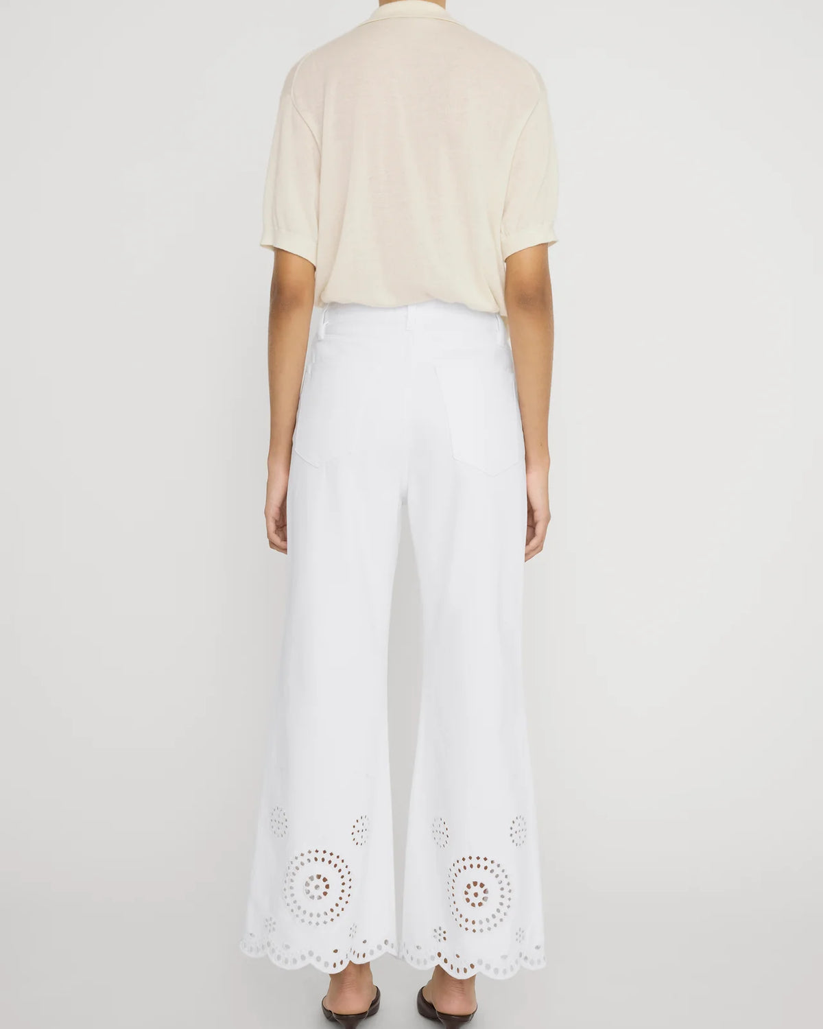 wide leg white denim pant with eyelet detail at the bottom
