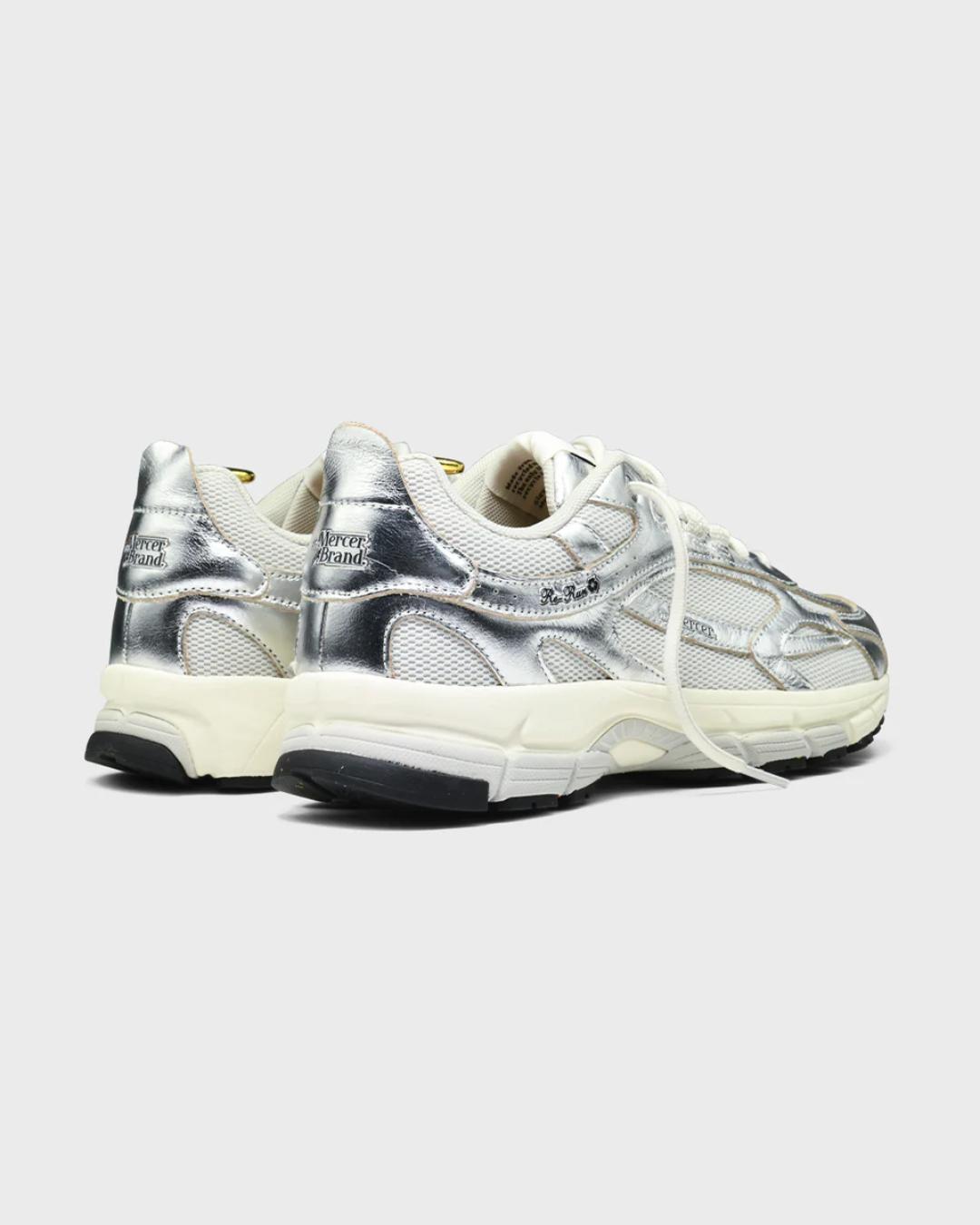 white running shoe with silvers accents