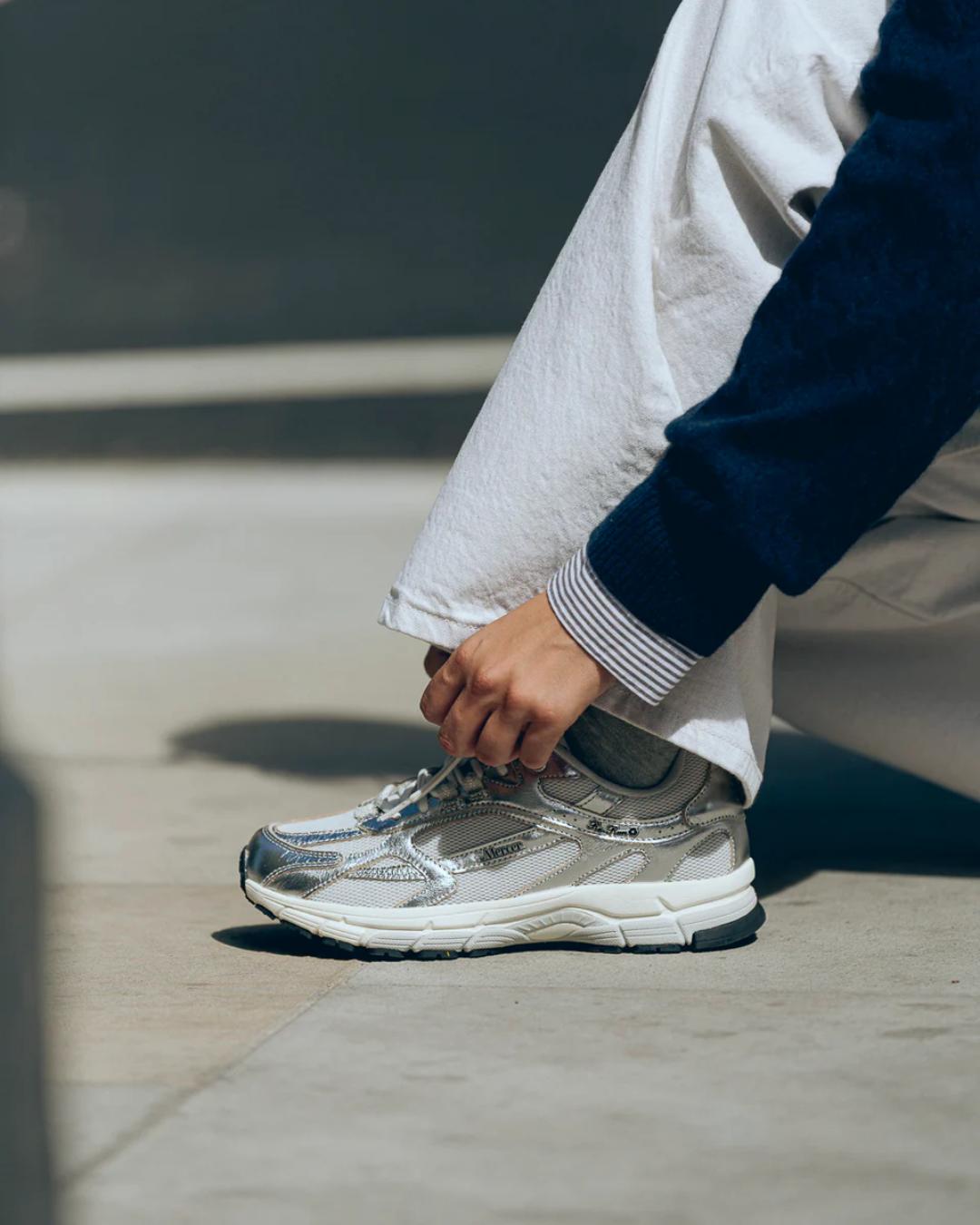 white running shoe with silvers accents