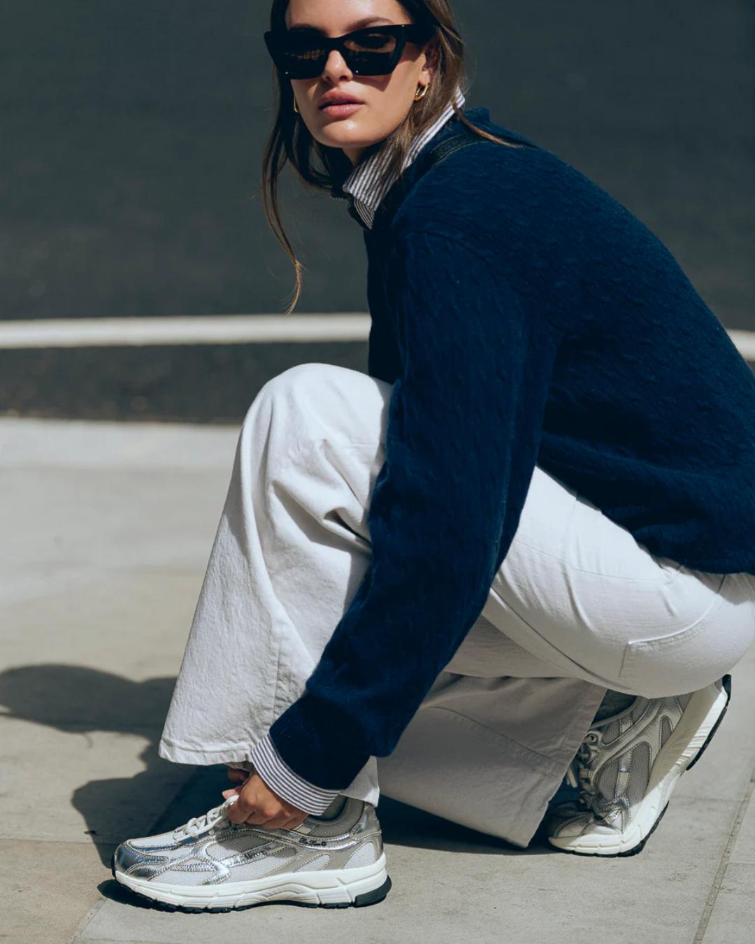 white running shoe with silvers accents