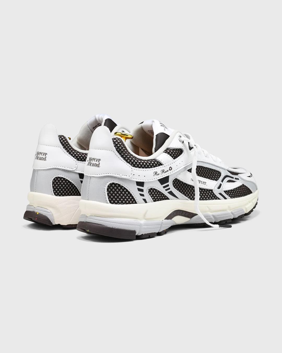 white and dark brown running shoe