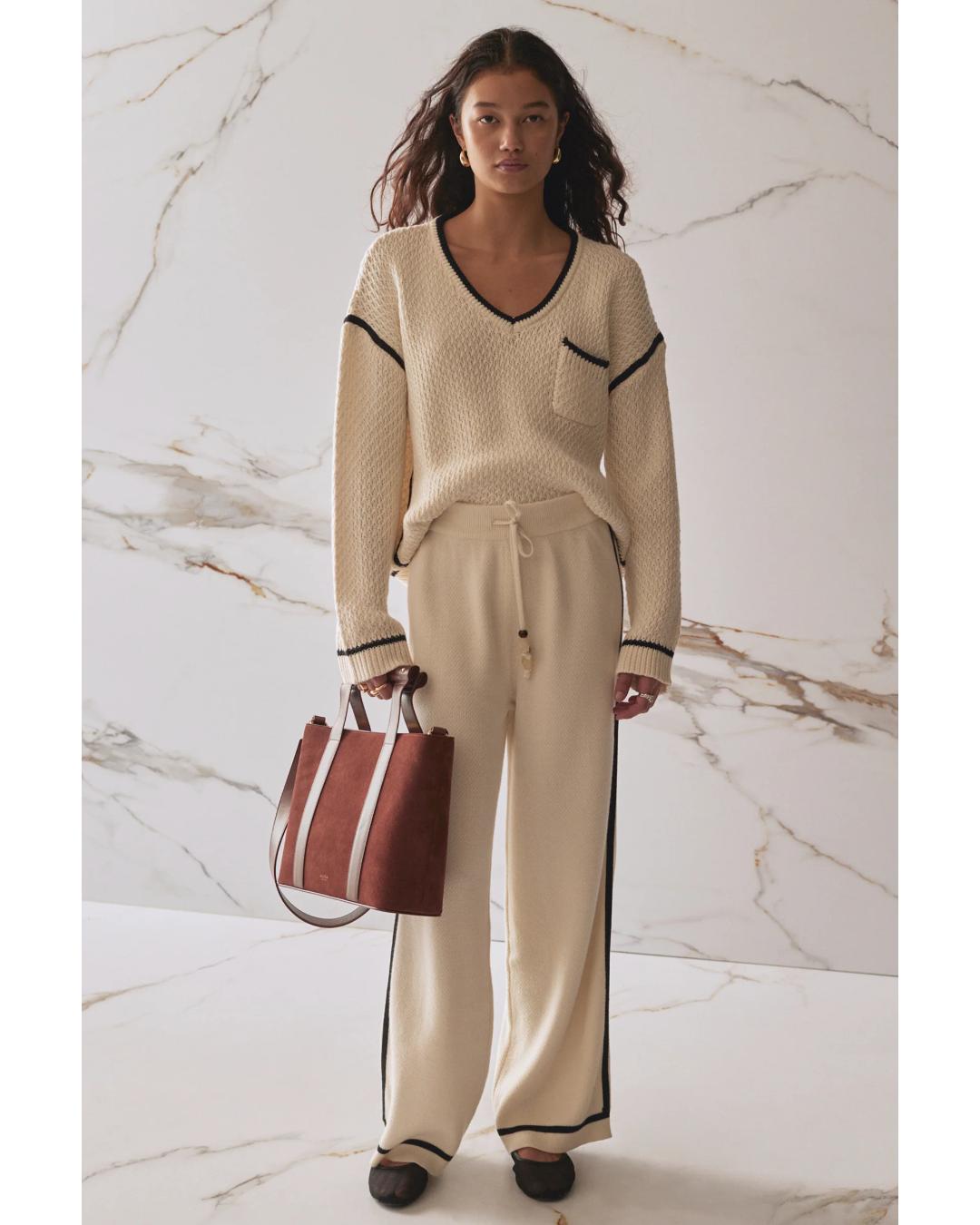 wide leg knit pant in beige and has a black stripe on the sides