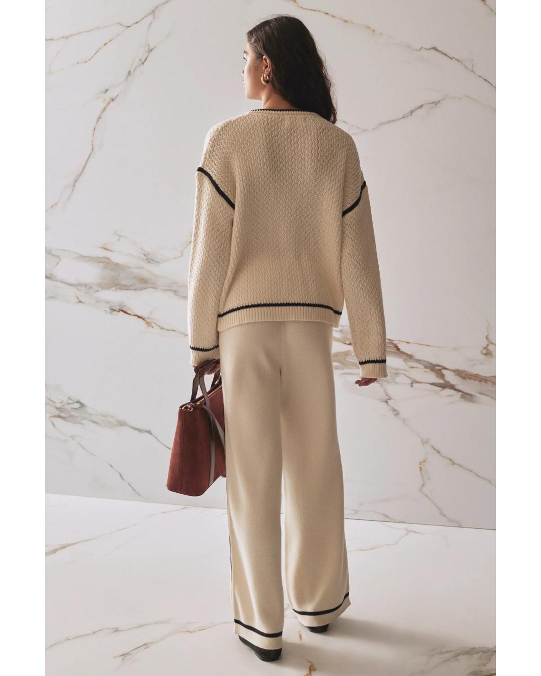 wide leg knit pant in beige and has a black stripe on the sides