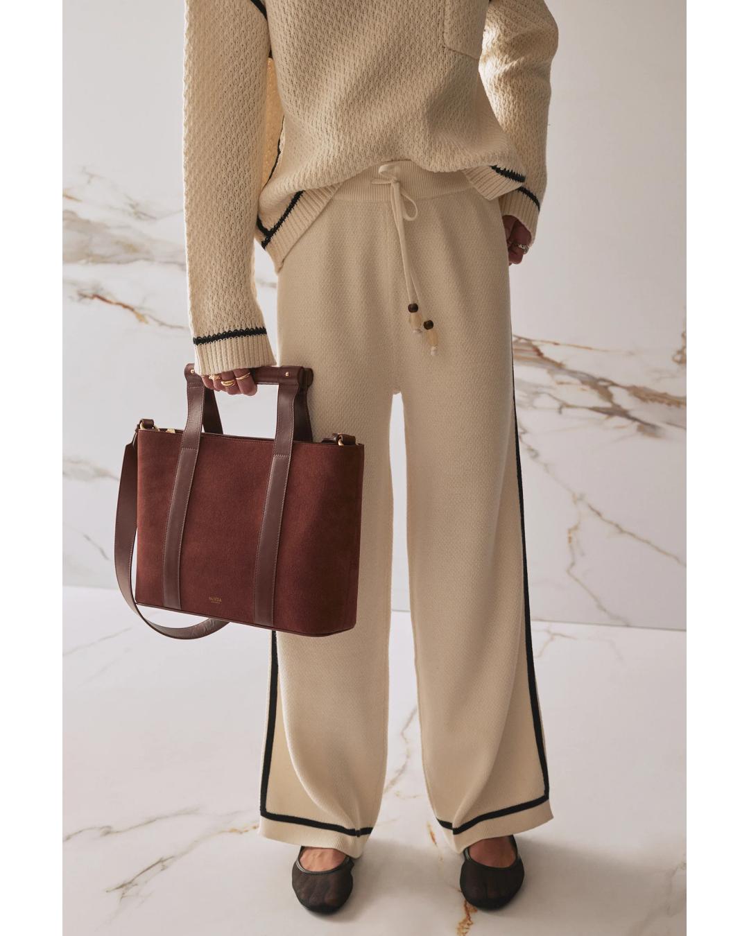 wide leg knit pant in beige and has a black stripe on the sides