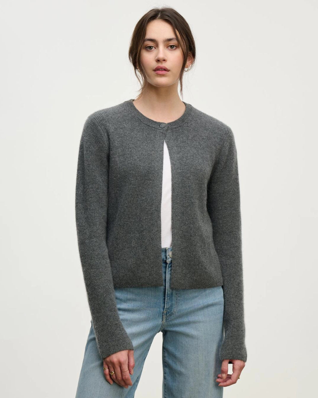 a woman wears a cashmere cardigan sweater in grey with a single button at the collar