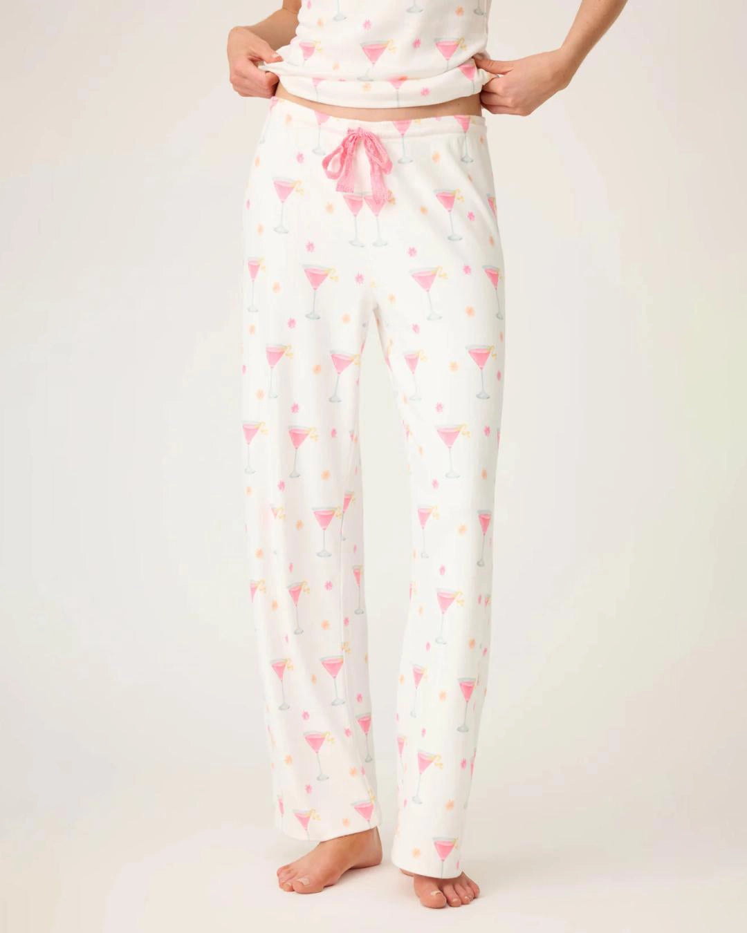 woman wearing pajamas pants with small pink martini glasses