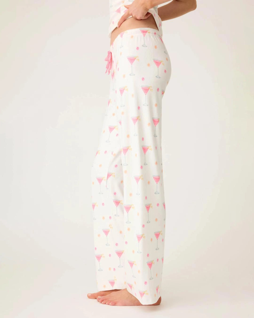 woman wearing pajamas pants with small pink martini glasses