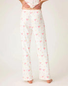 woman wearing pajamas pants with small pink martini glasses