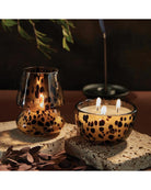 candle in a tortoise glass with a lid