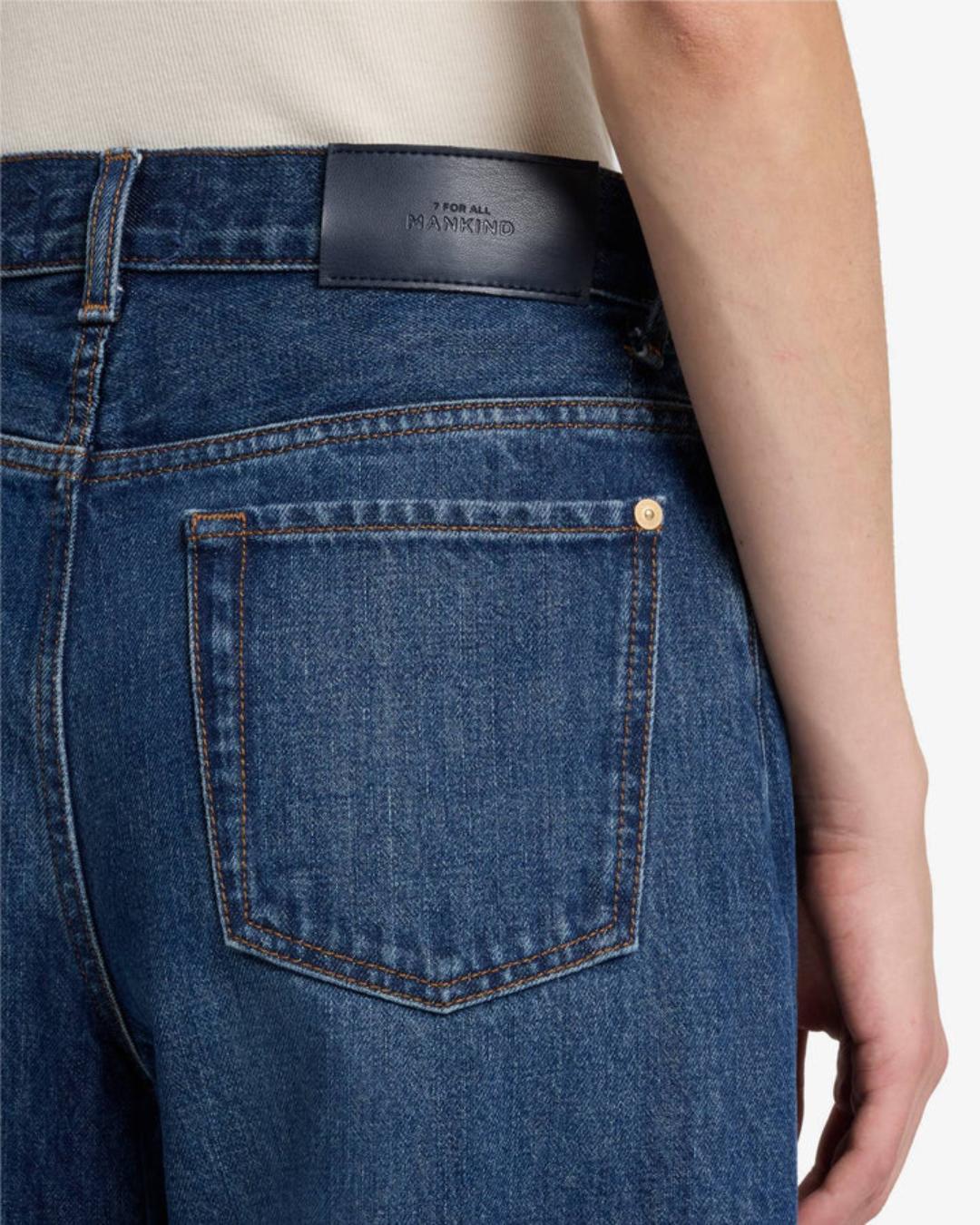 a woman wearing bonnie barrel jeans by 7 for all mankind