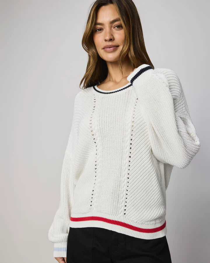 white sweater with navy at the collar and red at the bottom
