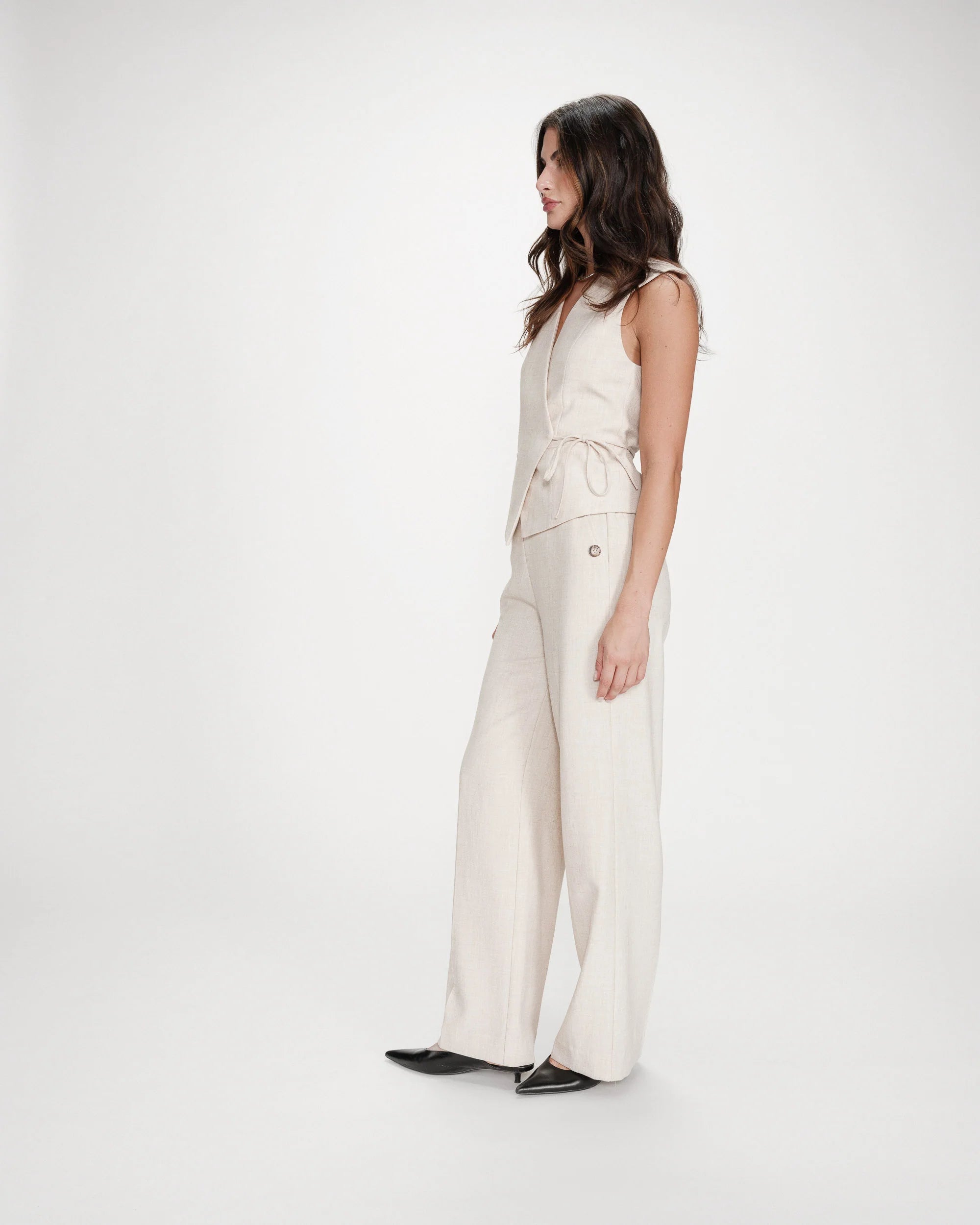 beige vest with a tie around the waist