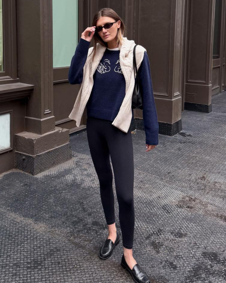 navy cashmere sweater with a white swan on the front