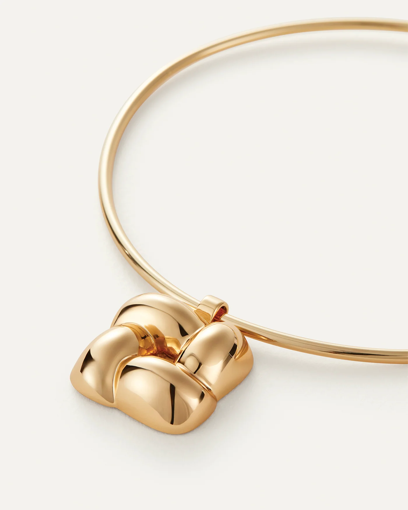 statement gold necklace with a woven pendant