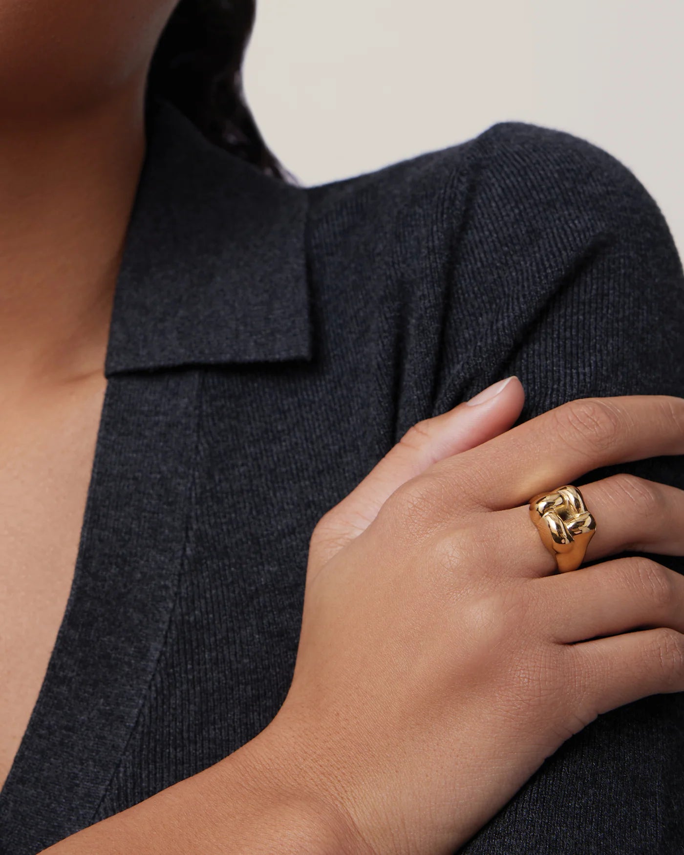 statement gold ring with a woven design on top