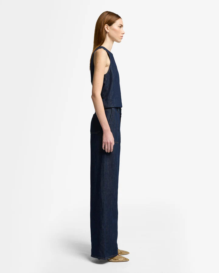 woman wearing dark blue wide-leg jeans by 7 for all mankind with utility pockets