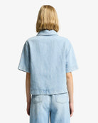 Person wearing a light blue denim jacket and pants 